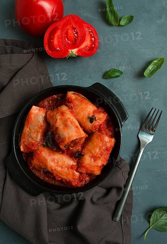 Stuffed cabbage rolls in tomato sauce stuffed cabbage leaves, minced meat with rice, on a dark background, top view, no people