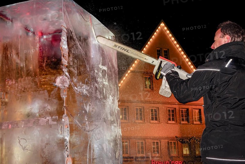 An ice sculpture is being created: ice carving street action as part of the long shopping night in the city center of Reutlingen, Baden-Württemberg, Germany, for editorial use only