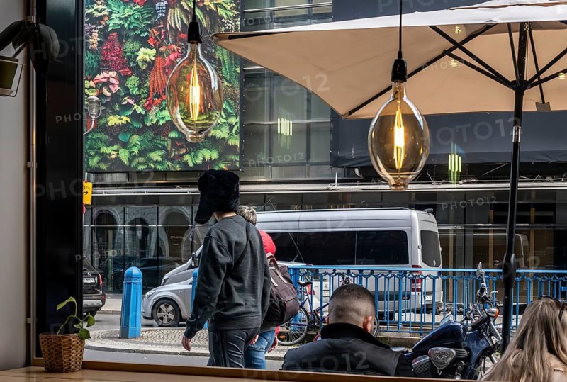 View through the window of a café of passers-by on Friedrichstraße in Mitte, Berlin, Germany