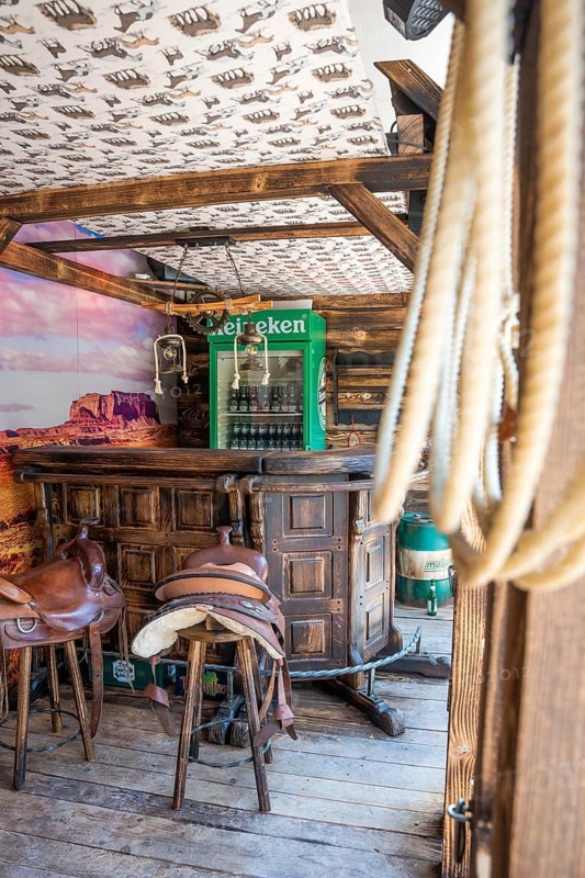 Rustic bar with saddle bar stools and drinks