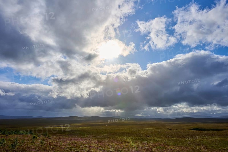 Landscape under dramatic sky with sunbeams and cloud formations, Lairg, Scotland, United Kingdom, Great Britain
