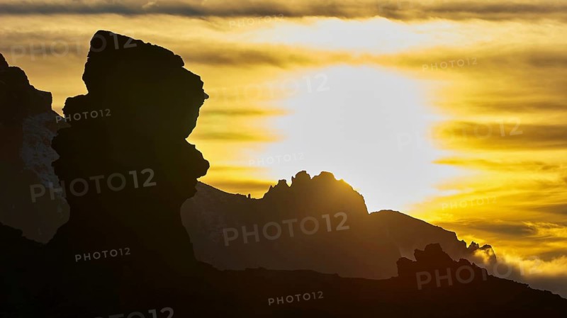 Dramatic rock silhouettes at sunset, golden light rays immerse the scene in warm light, Teide, Parque Nacional del Teide, Teide National Park, volcano, volcanism, UNESCO World Heritage Site, Tenerife, Canary Islands, Spain