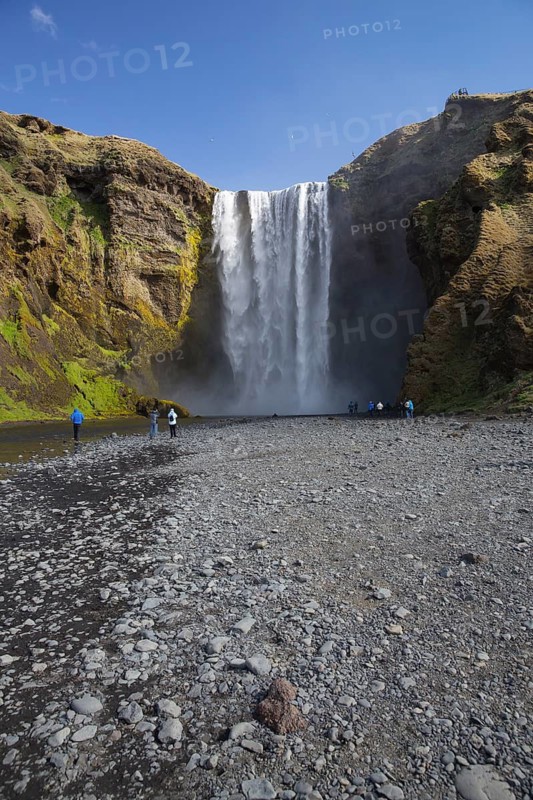 Skógafoss is a waterfall situated on the Skógá River in the south of Iceland. Height 60 m, width 25 m. People in front of the fall