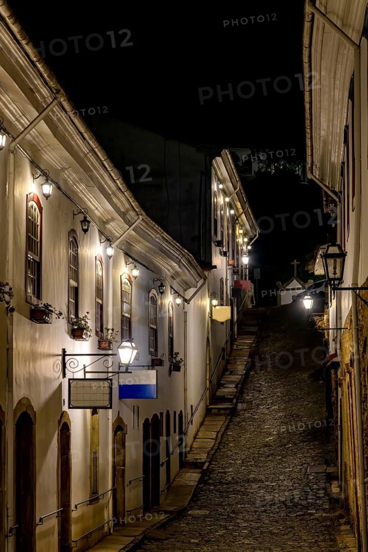 An alley in the historic city of Ouro Preto illuminated by lanterns at night, Ouro Preto, Minas Gerais, Brazil