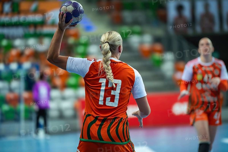 Female handball player with blond braid throw the ball in Lubin, Poland