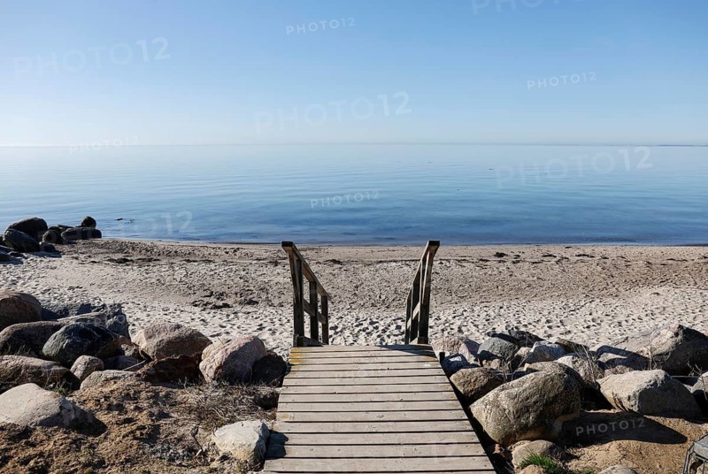 Morning atmosphere with calm sea on the Baltic Sea, stairs leading to the beach, Fehmarn island, 08.04.2026, Fehmarn, Schleswig-Holstein, Germany