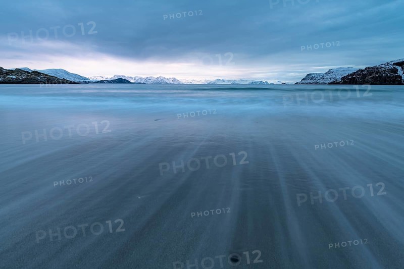 Ocean surf in sandy bay on the Norwegian European Sea at dusk, Söröya, Finnmark, November 2018