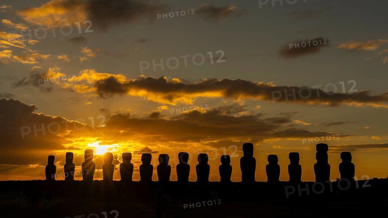 Silhouette moai statues placed in a row, sunrise with cloud vibes, Ahu Tongariki, Easter Island, Chile