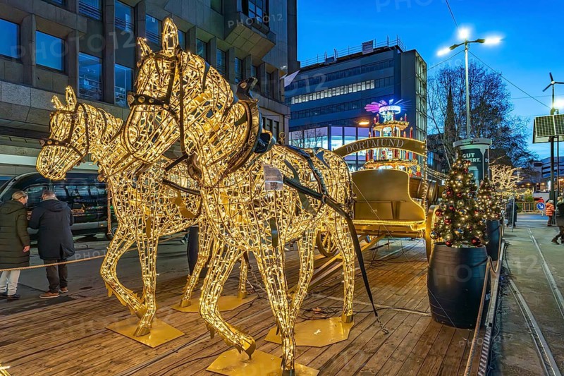 Light installation beer carriage with horses at Dortmund's Christmas market at dusk, Dortmund, North Rhine-Westphalia, Germany