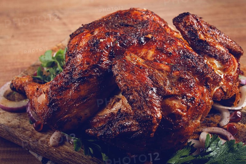 Whole fried chicken, with spices, grilled chicken, on a chopping board, top view, homemade, no people