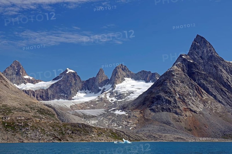 Impressive mountain range with snow-capped peaks on the water, Tiniteqilaaq, Tasilaq, Arctic, Greenland, Denmark