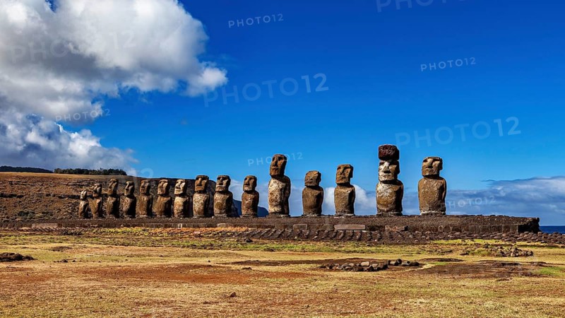 Row of Moai statues on a platform against a clear sky, The Moai statues on Easter Island in the Pacific Ocean