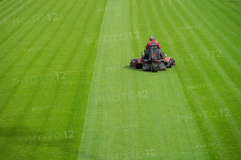 Mowing grass at the football stadium in Lubin, Poland