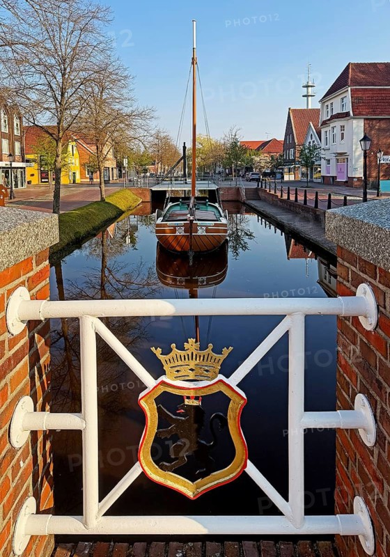 City coat of arms with open-air shipping museum on the main canal, museum ship Frisian Tjalk Thekla of Papenburg, Lower Saxony, Germany