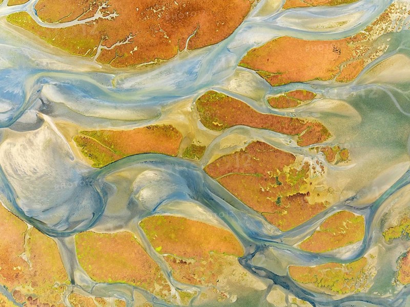 Streams at low tide in the marshland of the Walvis Bay lagoon. Aerial view. Drone shot. Walvis Bay, Namibia