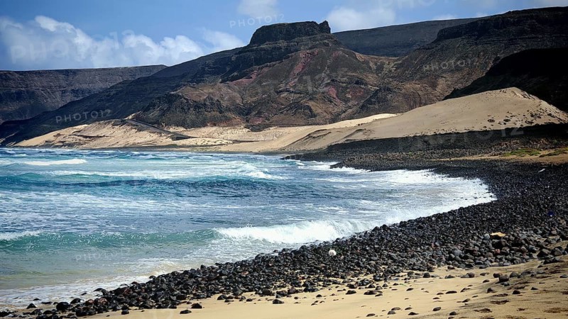 Lonely, secluded rocky coast with waves and mountains, illuminated by the sun, hiking Calhau, Baia das Gatas, Sao Vicente, Cabo Verde, Cape Verde, Cape Verde
