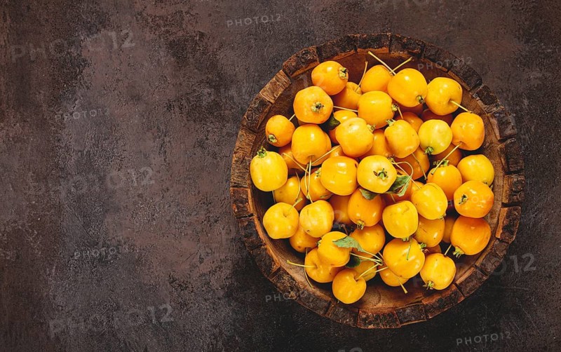 Yellow small apples, Chinese varieties, in a wooden bowl, top view, no people