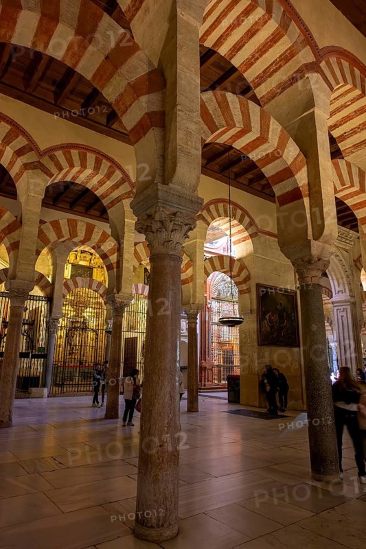 An illuminated area with arches and columns in the Cathedral Mosque of Córdoba (Mezquita-Catedral), Cordoba, Andalusia, Spain