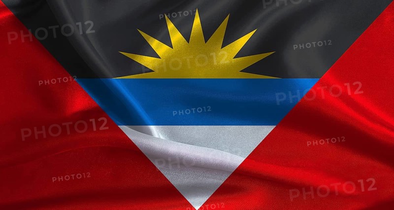 Antigua and Barbuda flag with cloth textured background. National flag of Antigua and Barbuda with realistic texture