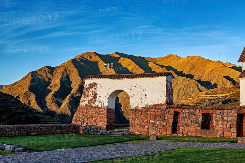 Ruins in front of a mountainous landscape in the soft light of sunrise, the historic village of Chinchero in the Sacred Valley of the Incas in Peru