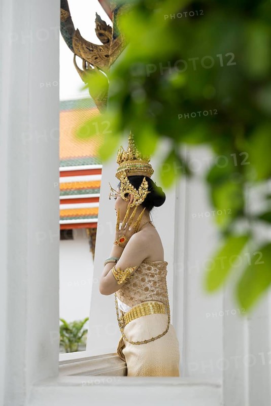 Thai traditionally and festively dressed young woman, Wat Pho, Bangkok, Thailand