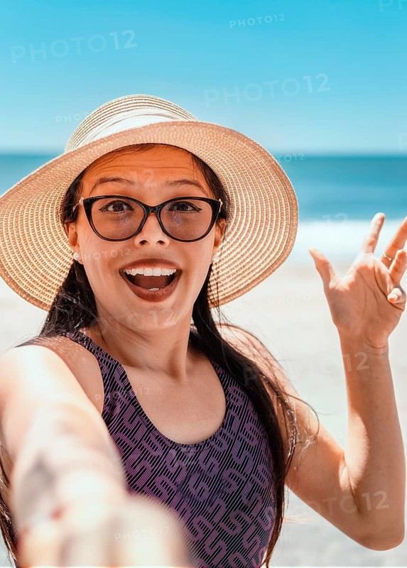 Pretty girl taking a selfie on the beach. Happy pretty young woman taking a selfie on the beach. vacation concept