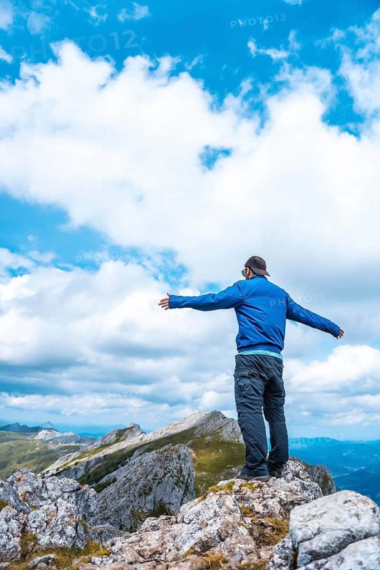 Mount Aizkorri 1523 meters, the highest in Guipúzcoa. Basque Country. Ascent through San Adrián and return through the Oltza fields. A young man in blue up on top