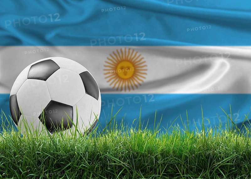 Soccer ball on pitch against Argentine flag in the background. Soccer ball on the grass with Argentina flag in the background