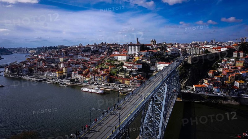 City panorama of the distinctive, spectacular Ponte Dom Luis 1 bridge over the Douro and old town under summer sky, Porto, Portugal