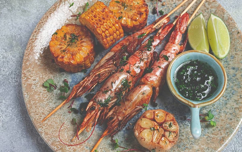 Langoustines on skewers, shrimp kebab, with fried corn, spices and herbs, homemade, no people