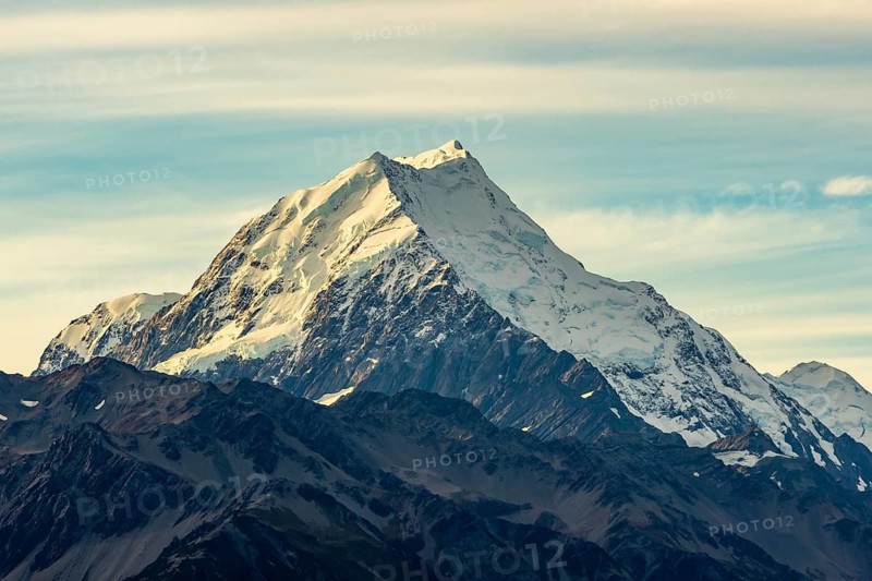 Serene beauty of Mount Cook in autumn, New Zealand. Snow capped peaks stand grand against a vivid sky, showcasing the region stunning natural splendor