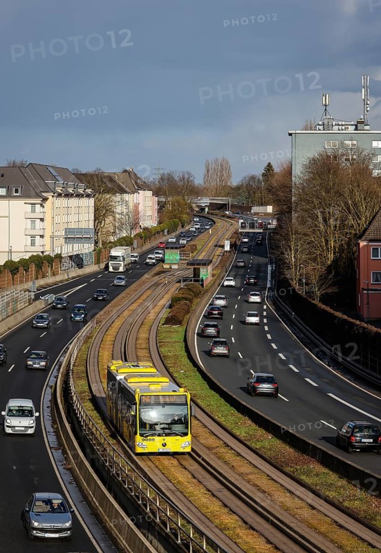 Essen, North Rhine-Westphalia, Germany - Cars and a public bus drive through Essen city centre on the A40 motorway