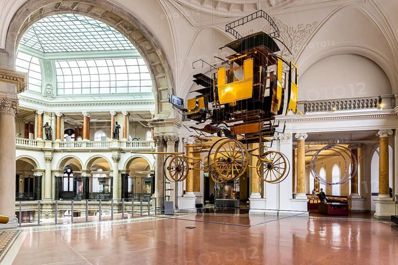 Museum of Communication in the building of the former Reich Post Ministry on Leipziger Straße, at the corner of Mauerstraße. stagecoach. A historic stagecoach hangs from the building's ceiling. Berlin, Germany