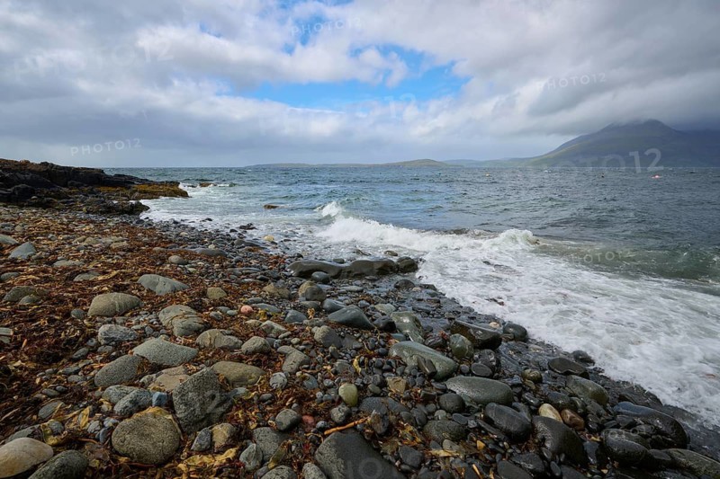 Stormy sea meets rocky coast with mountains and cloudy sky, Elgol Beach, Elgol, Isle of Skye, Scotland, United Kingdom, Great Britain