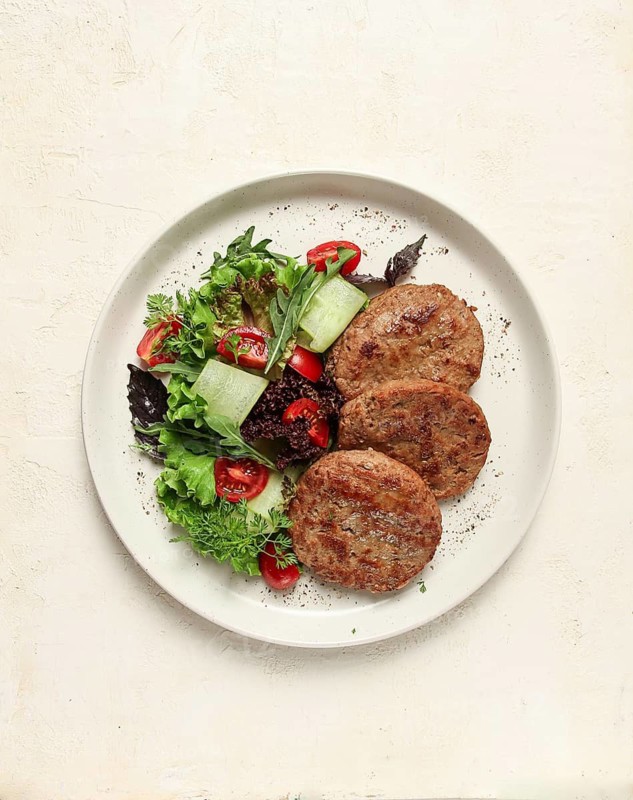 Fried cutlets, minced beef, with vegetable salad, top view, no people