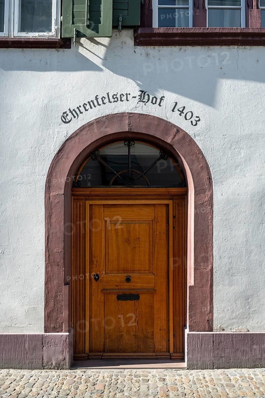 Classic wooden door with sandstone arch with the inscription Ehrenfelser Hof 1403 in the old town of Basel-Stadt, Canton of Basel, Switzerland