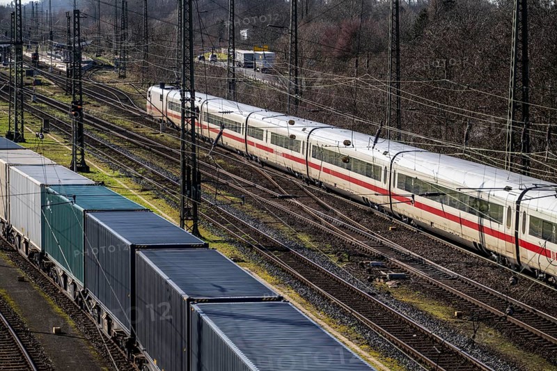 ICE long-distance train, on the line, container trains in the freight yard, so-called installation tracks in Duisburg-Rheinhausen, freight trains are parked here at short notice in front of continuing their journey, either to the trimodal terminal in Logport Duisburg or from there to distant destinations, such as China, as part of the new Silk Road, North Rhine-Westphalia, Germany