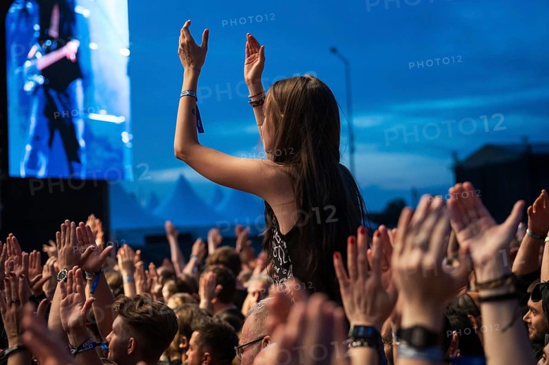JAROCIN, POLAND - JULY 18, 2025: Jarocin Festival 2025 with rock music. Woman applauding above the crowd of fans