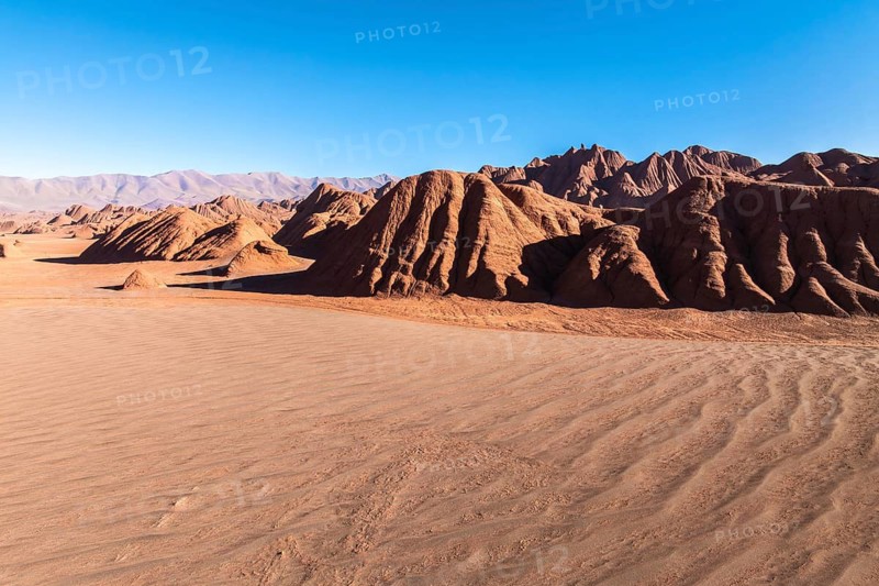 Vast and dramatic landscape of Devil's Desert in Salta, Argentina, showcasing unique rock formations under a clear blue sky, evoking the beauty of untouched nature