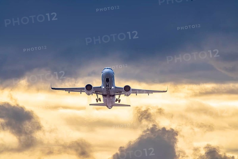 Stuttgart airport with plane taking off. Eurowings Airbus A320 in front of dark clouds, lighting in the evening. Stuttgart, Baden-Württemberg, Germany