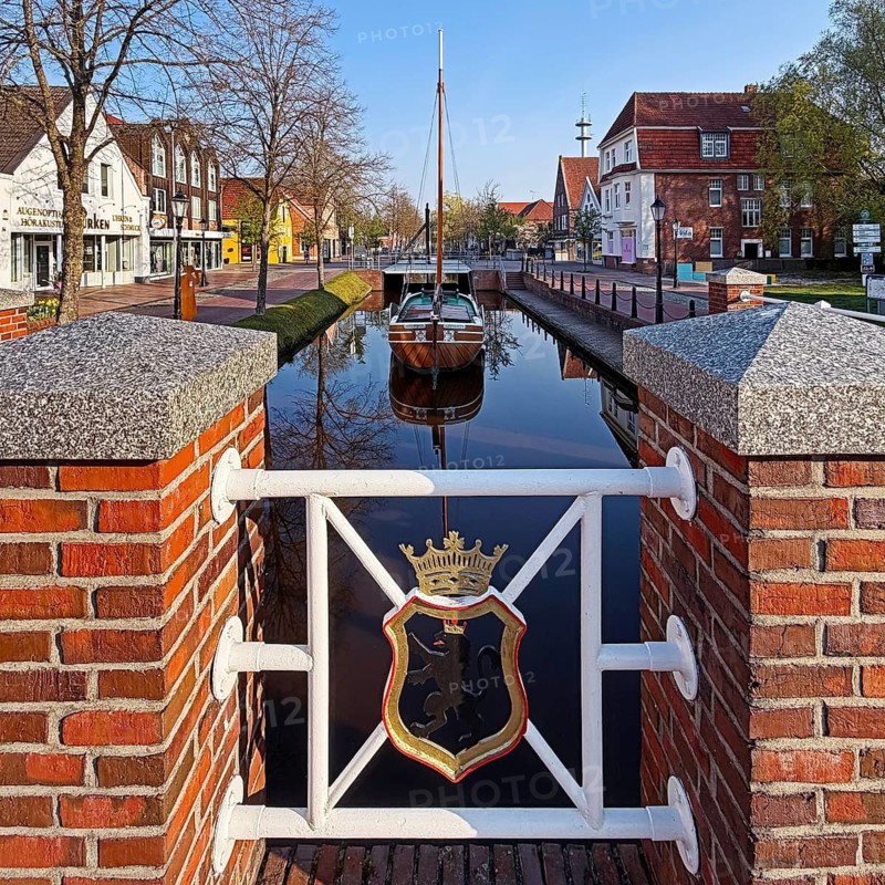 City coat of arms with open-air shipping museum on the main canal, museum ship Frisian Tjalk Thekla of Papenburg, Lower Saxony, Germany