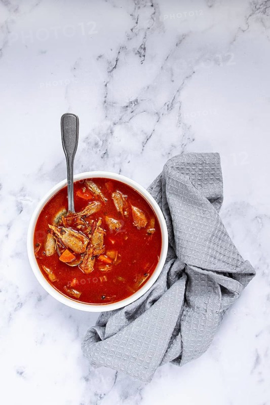 French shrimp bisque soup, on a marble table, close-up, no people