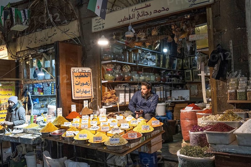 Damascus, Syria. December 10th 2025. A spice stall trader in Al-Buzuriyah Souq, a historical market in the ancient walled old city of Damascus, Syria