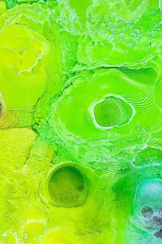 A vivid abstract design showcasing green liquids textures and circular patterns. The dynamic movement and vibrant hues create an energizing visual effect