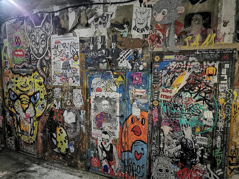 Wall with colorful graffiti and diverse illustrations in an urban environment, Berlin
