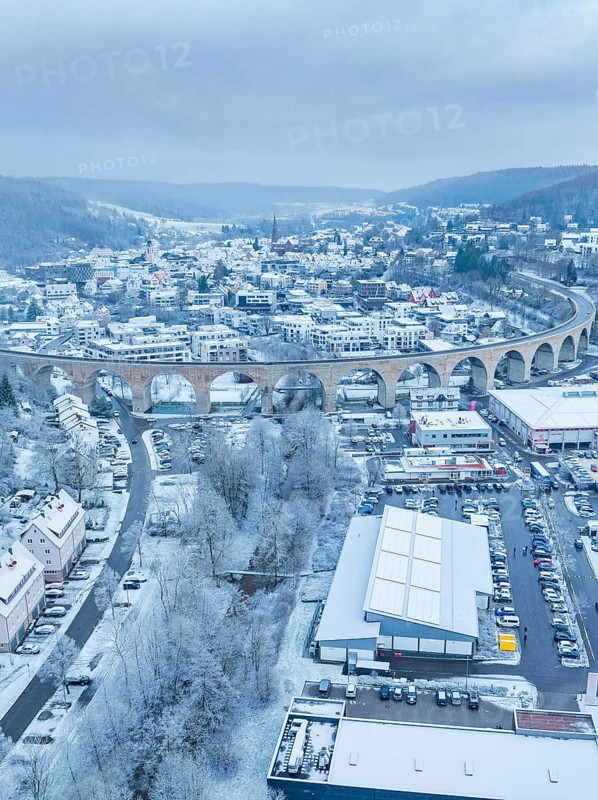 Aerial view of a town in winter with viaduct and snow-covered houses, Nagold, Black Forest, Germany