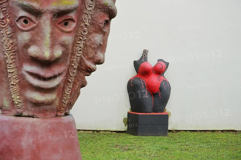 Two sculptures by artist Helmut Braig 2004, modern art, abstract art, two red faces with masks, female torso, sculpture park, Giengen an der Brenz, Swabian Jura, Baden-Württemberg, Germany