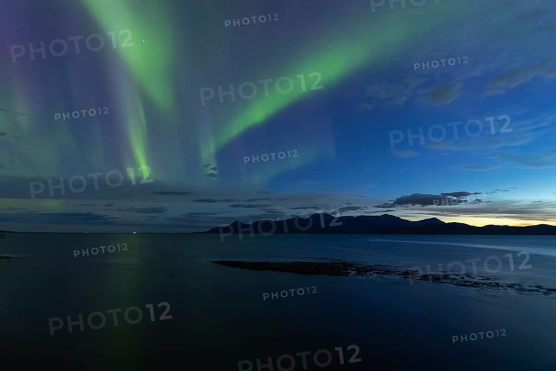 Northern lights at dawn over Sørfolda Fjord near Kjerringøy between Bodø and Sørfold in Norway