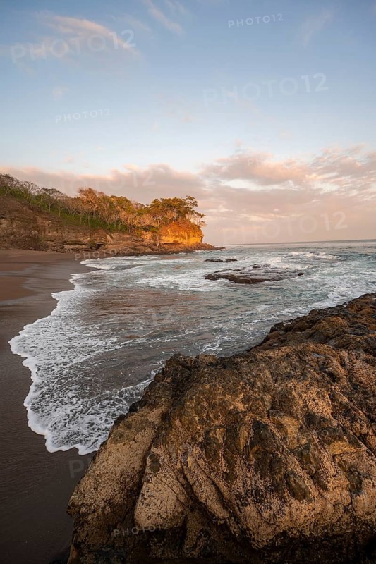 Sandy beach beach with rocks and sea at sunset, Playa Cocalito, coastal landscape, Pacific coast, Nicoya Peninsula, Puntarenas Province, Costa Rica