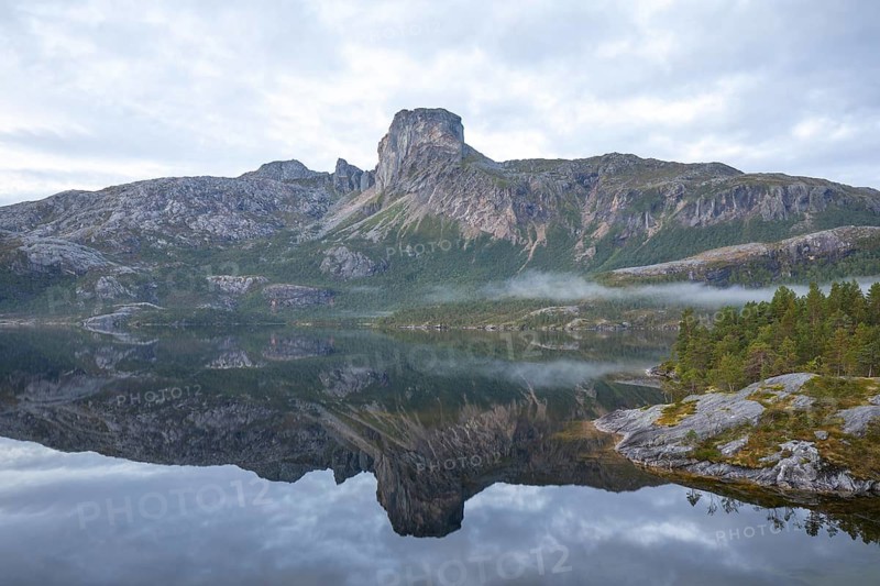 Magical morning fog on Steigtindvatnet in front of the majestic Steigtinden in Norway near Bodø